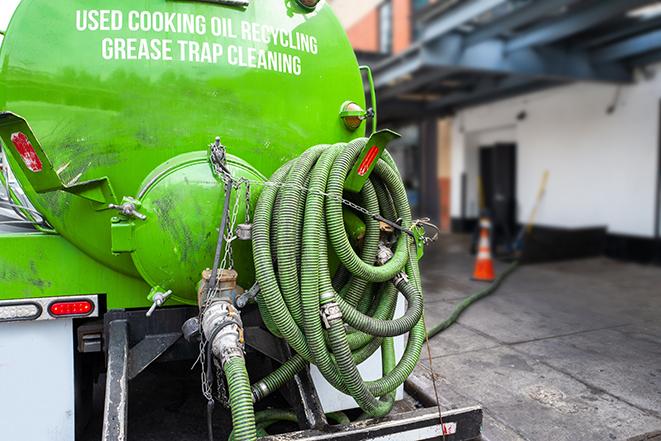 a technician pumping a grease trap in a commercial building in Bryn Mawr PA